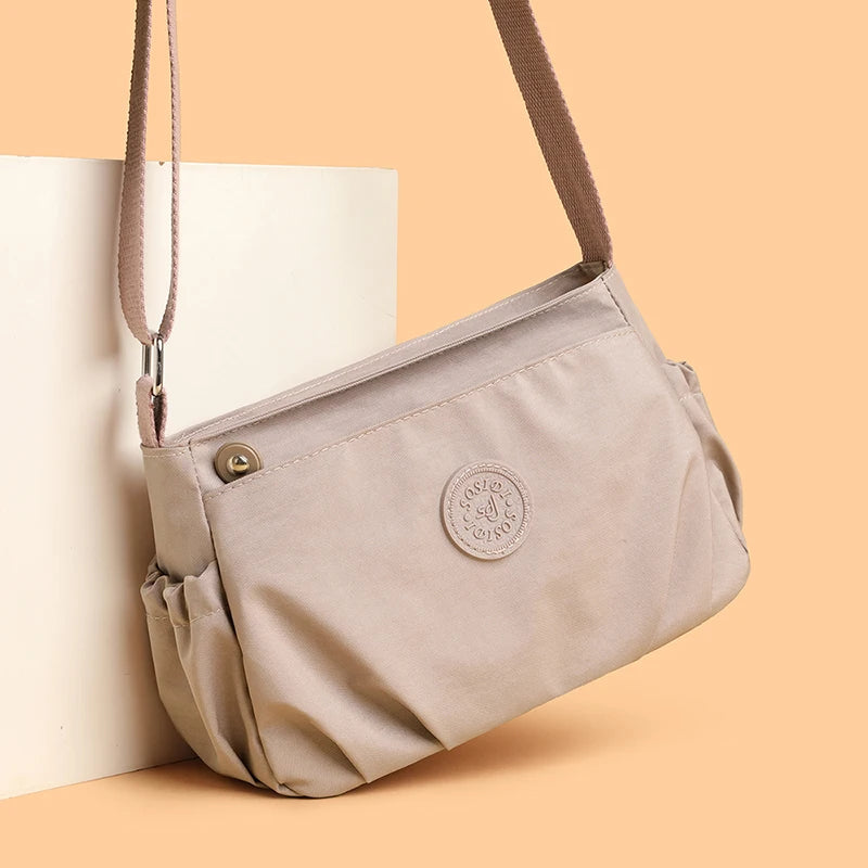 Women's Lightweight Water-Resistant Nylon Crossbody Bag | Front Zip Pocket | Adjustable Strap | Casual Everyday | Black · Burgundy · Pink · Beige