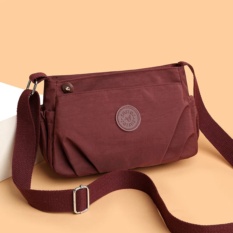 Women's Lightweight Water-Resistant Nylon Crossbody Bag | Front Zip Pocket | Adjustable Strap | Casual Everyday | Black · Burgundy · Pink · Beige