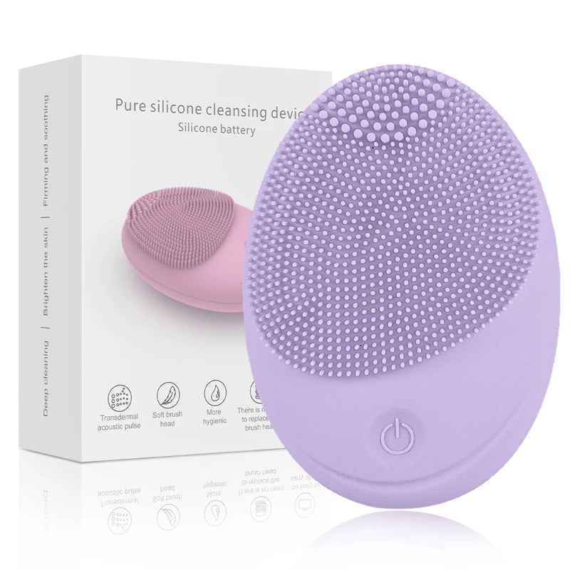 Purple oval facial cleansing device with textured bristles and a power button beside its box.