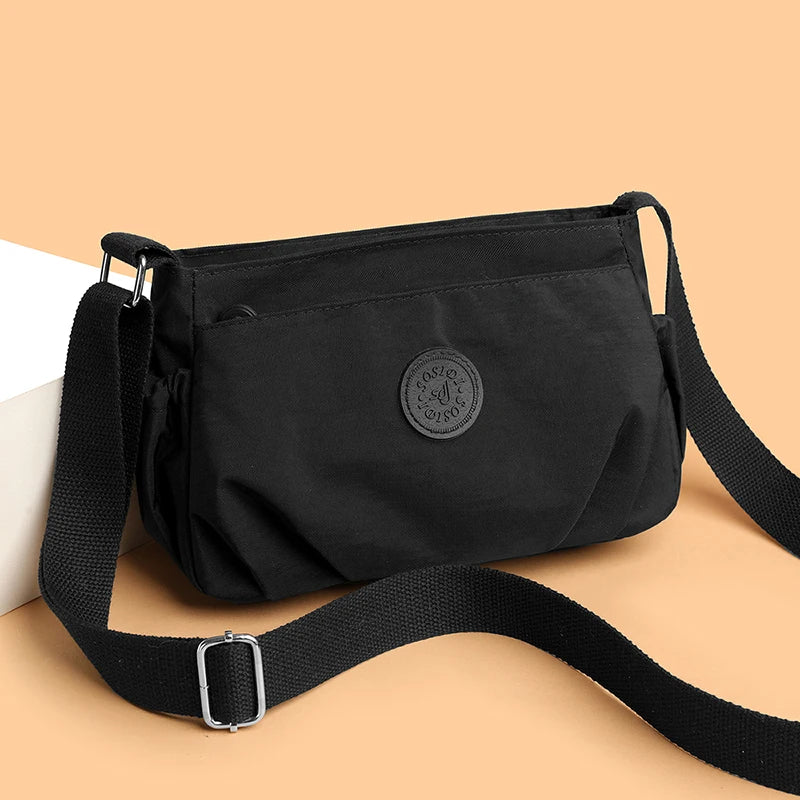 Women's Lightweight Water-Resistant Nylon Crossbody Bag | Front Zip Pocket | Adjustable Strap | Casual Everyday | Black · Burgundy · Pink · Beige